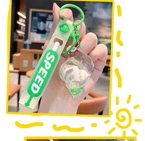 Close-up of a conch quicksand keychain with shell fillings and a green speed strap