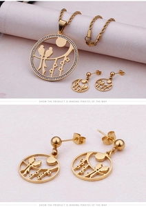 Detail of gold-plated bird and moon jewelry set featuring a necklace and drop earrings