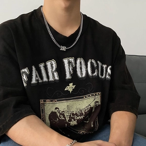 Hip hop silver Cuban chain necklace for men shown on a model with a black t-shirt