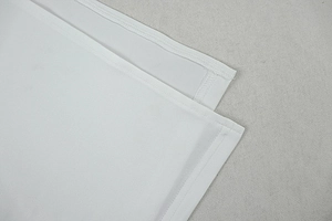 Close-up of the white dress hemline showing high-quality double-needle stitching detail
