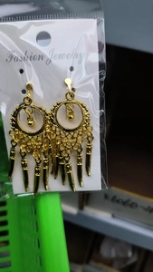 Bohemian gold tassel drop earrings showcased on a display card in retail packaging