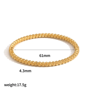 Polished gold stainless steel bamboo style bangle with beaded texture 61mm diameter