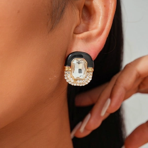 Close-up of vintage style black enamel earring with large crystal and paved rhinestones