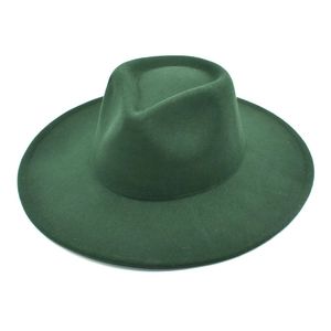Detail of dark green wide brim wool fedora hat with classic teardrop crown indentation