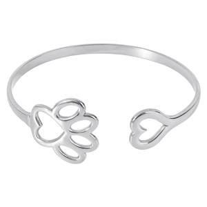 Detail of silver-tone open bangle with asymmetric heart and hollow paw print designs