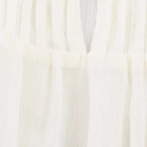 Close-up of white ruffled fabric texture with breathable and lightweight pleated detail