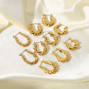Set of 18K gold plated stainless steel twisted hoop earrings on white silk background