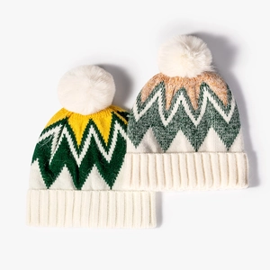 Winter striped knit beanie with pom-pom in yellow and green zigzag pattern for women