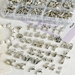 Macro view of silver Y2K charms set featuring hearts, butterflies, and metal pendants