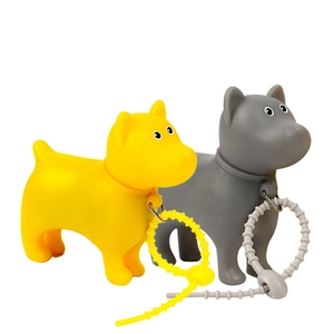 Detail of yellow and grey cartoon dog capsule dispensers with silicone hanging loops