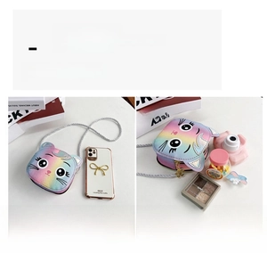 Internal capacity view of mini cartoon cat crossbody bag showing phone and lipstick storage