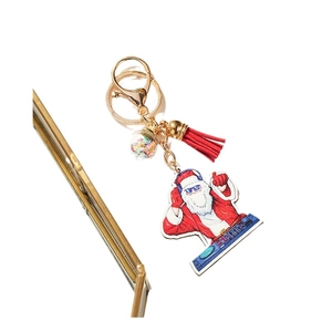 Christmas DJ Santa Claus keychain with red tassel and glitter globe on golden ring