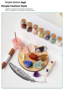 Detail view of healing crystal set with gemstone drift bottles and feather bookmark