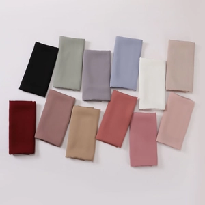 Folded solid color lightweight chiffon headscarves in multiple vibrant colors on white