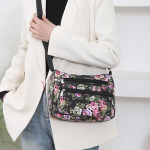 Floral print nylon crossbody bag for women with adjustable strap shown on a model