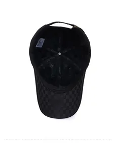 Detail of warm black winter baseball cap showing plush faux fur lining and checkered brim