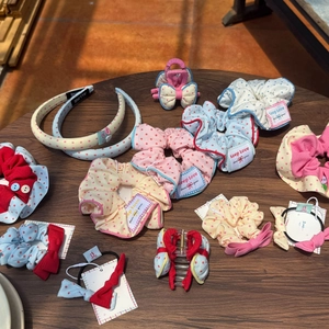 Vibrant polka dot hair accessory set featuring scrunchies, headbands, and bow clips on a table