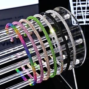Sparkling crystal headbands in seven colors displayed on an acrylic stand with black background