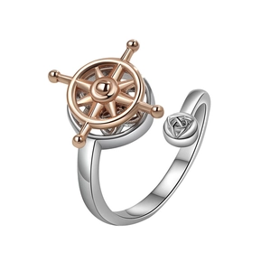 Rotating stainless steel ship wheel ring with Celtic knot design on white background