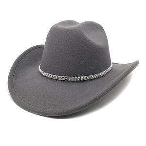 Detail of dark grey wool cowboy hat with rhinestone hatband on white background