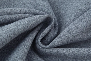 Macro shot of grey wool blend fabric showing fine fiber texture and thick material quality