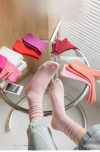 Magazine style detail of colorful cotton ribbed socks with various candy colors on display