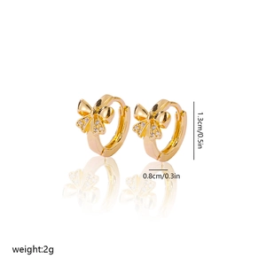 Detail view of gold-plated bow earrings with white zircon paving and size dimensions