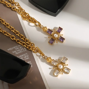 Chic gold-plated cross necklaces with pearls and gemstones on a fashion magazine