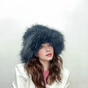Close-up of black faux fur plush hat with long hairy texture for winter punk style