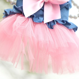 Detail of pet denim dress featuring a pink satin bow and layered mesh tutu skirt