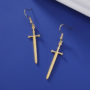 Detailed view of long sword drop earrings with 18k gold plating on blue background