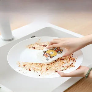 Detail showing cartoon bear cellulose sponge cleaning a greasy white ceramic dish