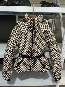 Detail of hooded ski jacket with geometric diamond pattern and waist-cinching belt