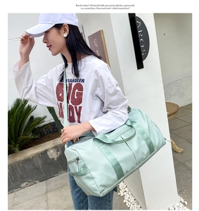 Mint green large capacity travel bag showing the side zipper compartment and shoulder strap