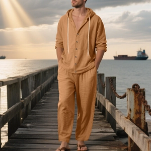Detail of ginger linen hoodie set showing natural fabric texture at the seaside sunset