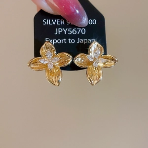 Detail of gold flower stud earrings with marquise cubic zirconia on 925 silver card