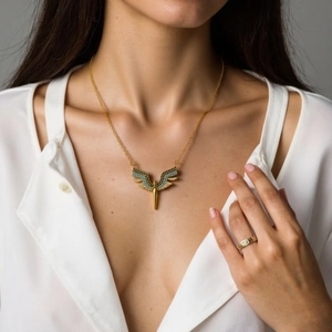 Golden wing necklace with blue zircon stones on a gold chain for women in boho style