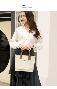 Stylish canvas tote bag for women, casual handbag with top handles and front pocket detail.