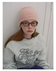 Close-up of pink textured wool blend beanie with horizontal ribbed pattern and soft fiber detail