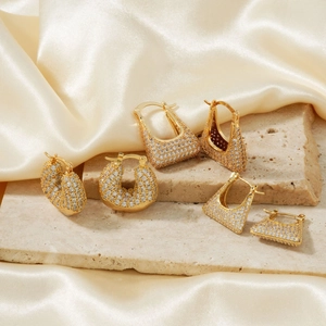 Three pairs of vintage gold earrings with geometric shapes and micro-paved zircons
