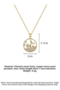 Detail of gold fishtail pendant necklace with sparkling cubic zirconia on titanium chain