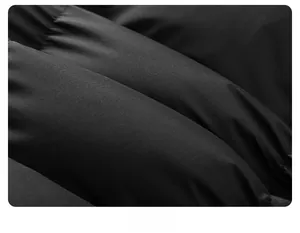Macro shot of black quilted fabric showing premium texture and puffy down filling