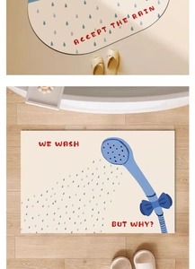 Detail view of semi-circle and rectangular beige absorbent bath mats with blue raindrop patterns