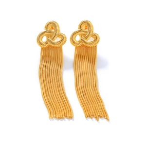 Macro detail of 18k gold plated stainless steel knot earrings with long tassel chains