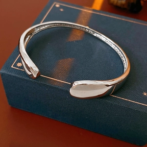 Detailed view of silver-plated drop cuff bracelet with mirror-polished surface finish