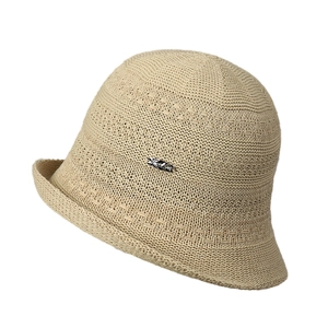 Beige knitted bucket hat with hollow texture and silver metal plate on white background