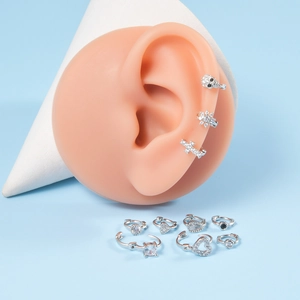 Silver butterfly and snake ear cuff set with sparkling zircon on a blue background