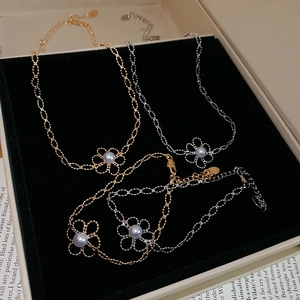 Detailed shot of gold and silver flower bracelets with pearls in a jewelry display box