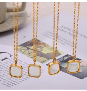 Detailed view of four gold titanium steel necklaces with square resin shell pendants