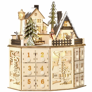 Detail of wooden Christmas advent calendar with 24 drawers, LED lights and winter village scene